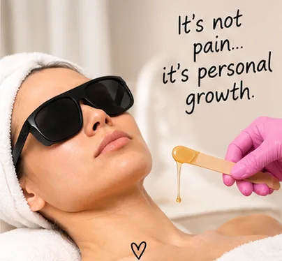A woman in eye-protection goggles having warm wax applied, captioned: it is not pain, it is personal growth